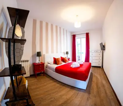 a bedroom with a bed with a red blanket at Urban Trastevere Rome apartment Ripa 11 in Rome