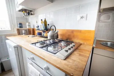 a kitchen with a stove with a tea kettle on it at Urban Trastevere Rome apartment Ripa 11 in Rome