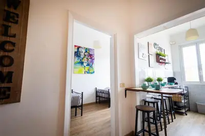 a kitchen and dining room with a bar and stools at Urban Trastevere Rome apartment Ripa 11 in Rome
