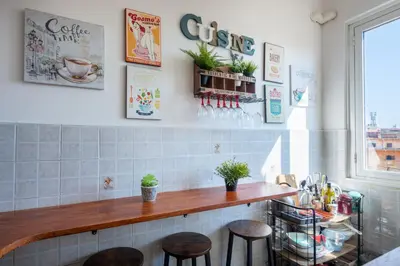 a kitchen with a counter and stools in a room at Urban Trastevere Rome apartment Ripa 11 in Rome