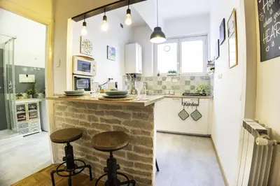 a kitchen with a counter and two stools at Boutique Trastevere Rome apartment Ripa 12 in Rome
