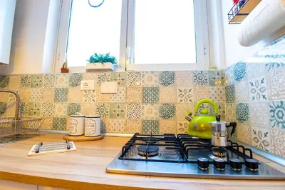 a kitchen counter with a stove top in a kitchen at Boutique Trastevere Rome apartment Ripa 12 in Rome