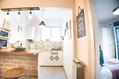 a small kitchen with white cabinets and a counter at Boutique Trastevere Rome apartment Ripa 12 in Rome