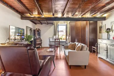 a living room with a couch and a table at Pantheon Penthouse in Rome