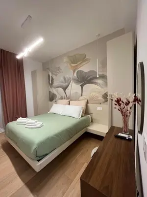 a bedroom with a bed with a painting on the wall at Saint Paul Gateway in Rome