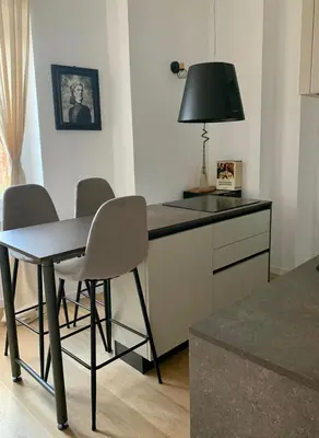 a kitchen with a table and chairs and a lamp at Saint Paul Gateway in Rome