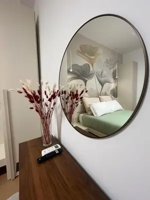 a mirror reflecting a bedroom with a bed and a table at Saint Paul Gateway in Rome