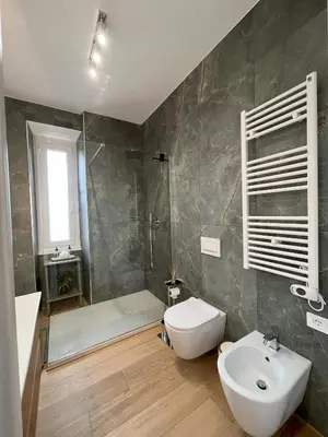 a bathroom with a toilet and a sink and a shower at Saint Paul Gateway in Rome