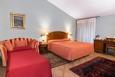 a hotel room with two beds and a couch at Hotel Bramante in Rome