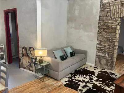 a living room with a couch and a table with a lamp at Monti Urban Loft by Valentina's Dream in Rome