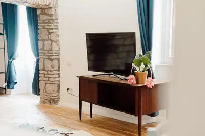 a television sitting on top of a dresser in a room at Monti Urban Loft by Valentina's Dream in Rome
