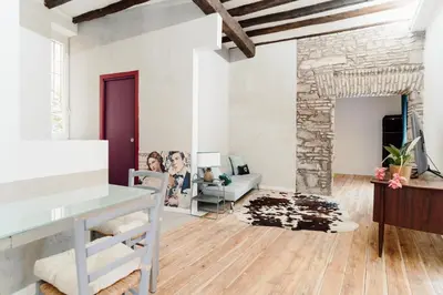 a living room with white walls and wooden floors at Monti Urban Loft by Valentina's Dream in Rome