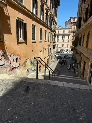 an empty street with a building with graffiti at Monti Urban Loft by Valentina's Dream in Rome