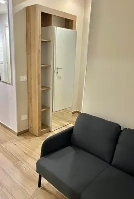 a living room with a couch and a closet at SAINT PETER home and holiday apartment in Rome