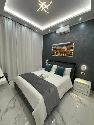 a bedroom with a bed with a blue pillow at Medaglie d'Oro Vaticano in Rome