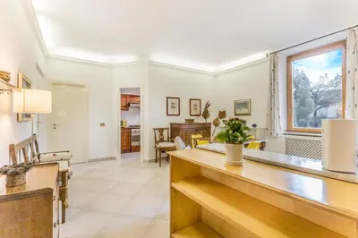 a room with a bench and a painting on the wall at Emanuele House by GHOR in Rome