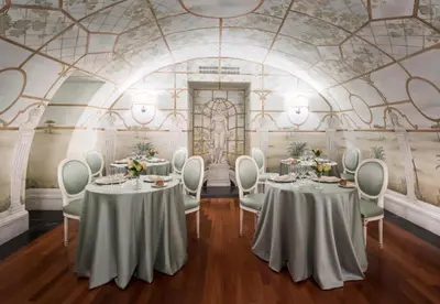a room with two tables and chairs and a ceiling at Hotel Ponte Sisto in Rome
