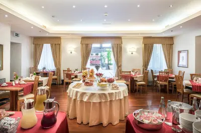 a dining room with a table with food on it at Hotel Ponte Sisto in Rome