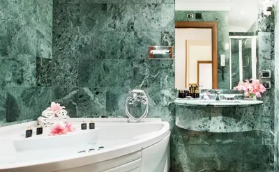 a bathroom with a white tub and a sink at Hotel Ponte Sisto in Rome