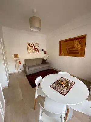 a living room with a white table and chairs at Garbatella, lovely mini apartment in Rome