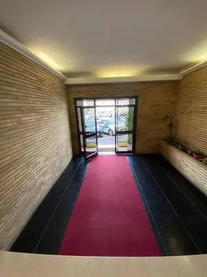 a room with a red carpet and a door at Garbatella, lovely mini apartment in Rome