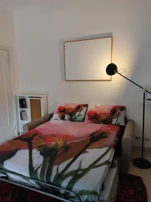 a bedroom with a bed and a lamp and a picture at Garbatella, lovely mini apartment in Rome