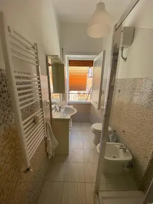 a bathroom with a sink and a toilet and a mirror at Armandino's sweet home Roma in Rome