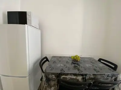a table in a kitchen next to a refrigerator at Armandino's sweet home Roma in Rome