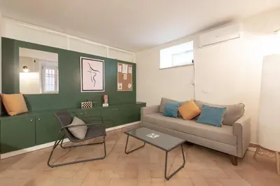 a living room with a couch and a table at Peaceful hidden gem near Metro A and Colosseum in Rome