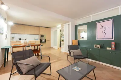 a kitchen and living room with a table and chairs at Peaceful hidden gem near Metro A and Colosseum in Rome