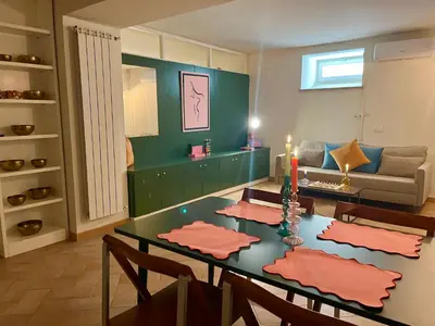 a living room with a table and a couch at Peaceful hidden gem near Metro A and Colosseum in Rome