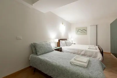 a bedroom with two beds and a couch in it at Peaceful hidden gem near Metro A and Colosseum in Rome