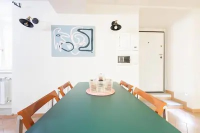 a dining room with a blue table and chairs at Peaceful hidden gem near Metro A and Colosseum in Rome