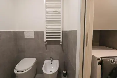 a small bathroom with a toilet and a sink at Modern Deluxe 2 Suites Apartment - 15min Colosseum & Metro 5min - AC, Wifi in Rome