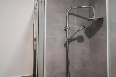 a shower stall with a shower head in a bathroom at Modern Deluxe 2 Suites Apartment - 15min Colosseum & Metro 5min - AC, Wifi in Rome