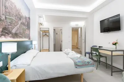 a hotel room with a bed and a desk at Domus suites in Rome