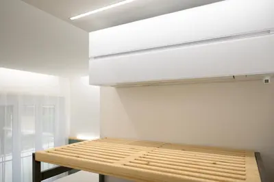 a bedroom with a wooden bed in a wall at Domus suites in Rome