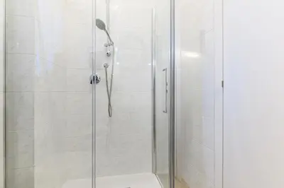 a shower stall with a glass door in a bathroom at Giardinetto 14 in Rome