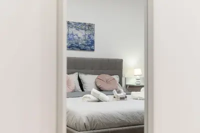 a mirror reflection of a bed in a bedroom at Giardinetto 14 in Rome