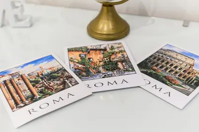 a table with four photos of rome on it at Giardinetto 14 in Rome