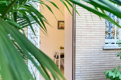 a door to a house with a palm tree at Giardinetto 14 in Rome