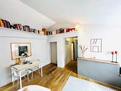 a living room with a desk and a table at The Artist's nest - Trastevere- Rome in Rome