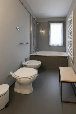 a bathroom with a toilet and a sink and a tub at The Artist's nest - Trastevere- Rome in Rome