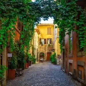 an alley in an old town with trees and buildings at The Artist's nest - Trastevere- Rome in Rome