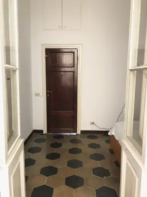 a room with a door and a checkered floor at Boschetto Apartment in Rome