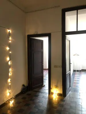 an empty room with a door and lights on the wall at Boschetto Apartment in Rome
