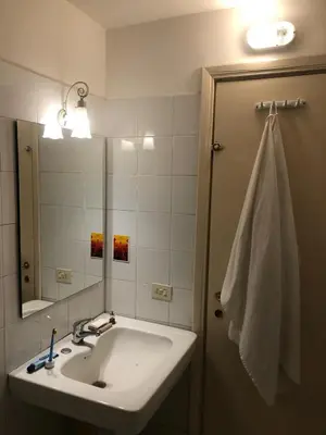 a bathroom with a sink and a mirror at Boschetto Apartment in Rome