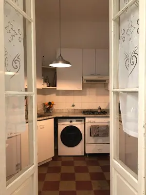 a kitchen with a stove and a dishwasher at Boschetto Apartment in Rome