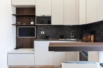 a kitchen with white cabinets and a counter top at Bartolomeo de' Vaccinari - FromHometoRome in Rome