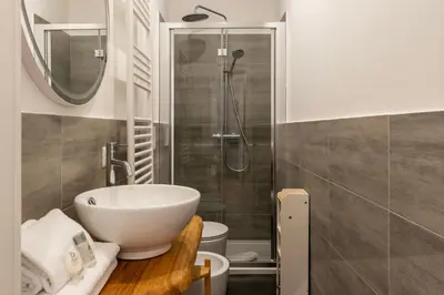 a bathroom with a sink and a shower at Bartolomeo de' Vaccinari - FromHometoRome in Rome